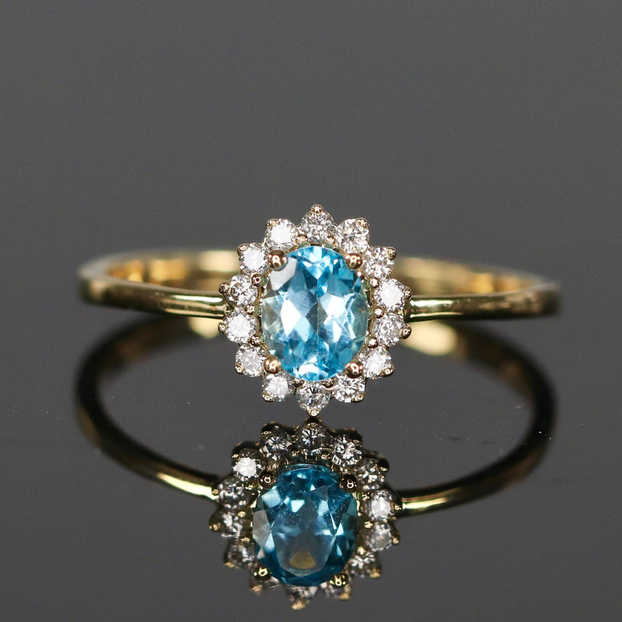 Blue topaz and diamond ring in yellow gold