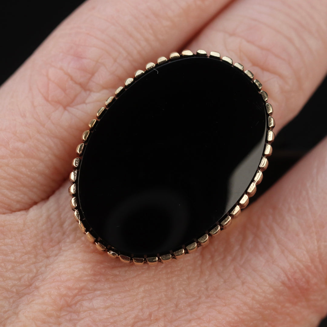 Vintage onyx ring with large oval onyx in 14k yellow gold from Manor Jewels.