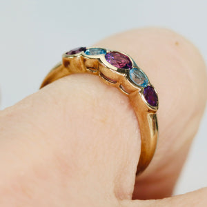 Amethyst and blue topaz band in yellow gold