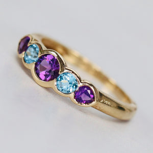 Amethyst and blue topaz band in yellow gold