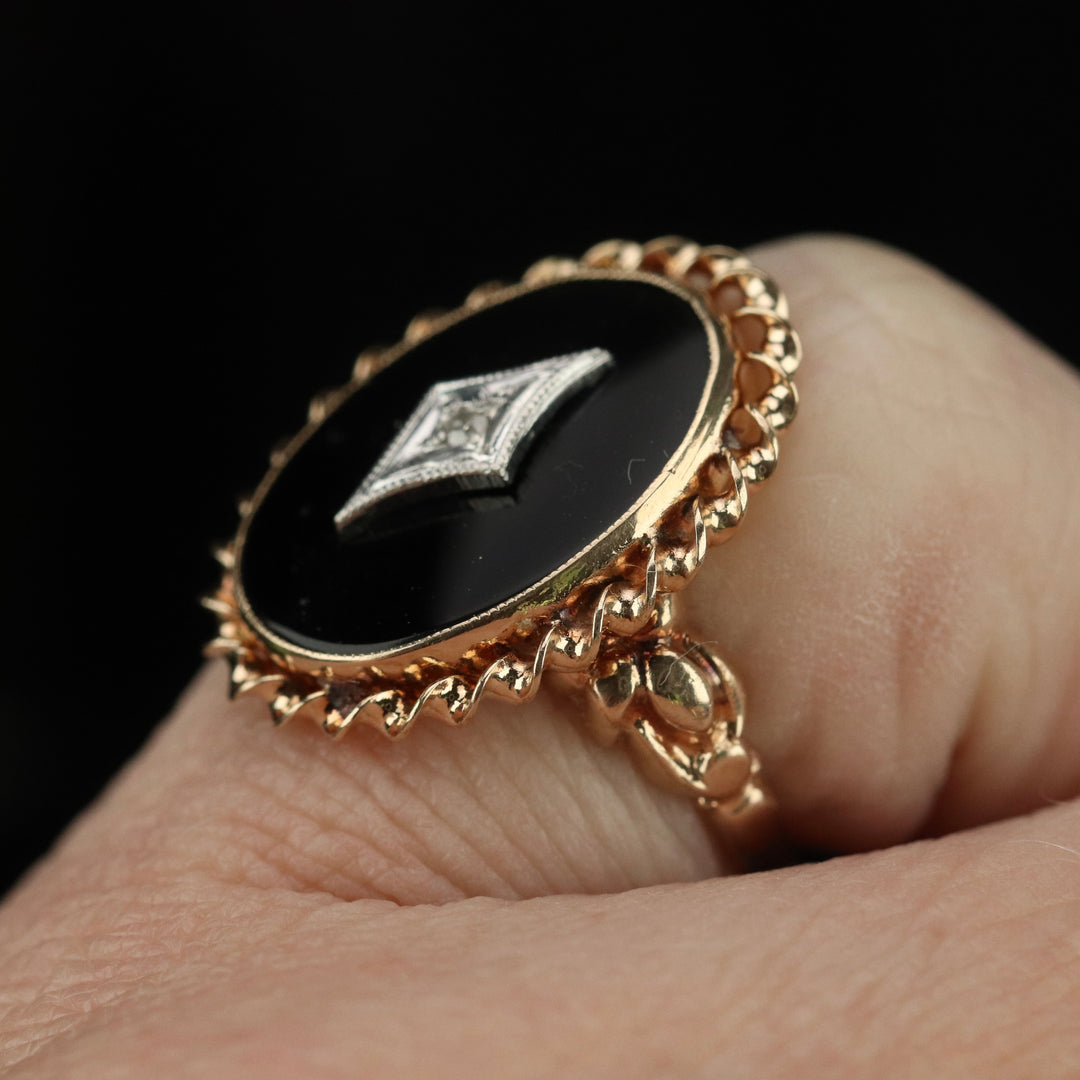 Classic vintage onyx and diamond ring in yellow gold