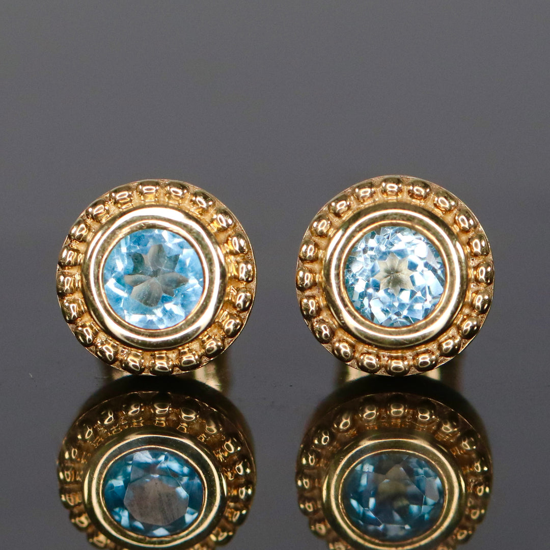Blue topaz stud earrings in yellow gold