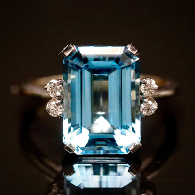Emerald cut blue topaz and diamond ring in 14k white gold
