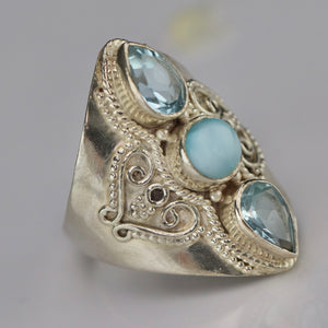 Sterling silver laminar and blue topaz ring