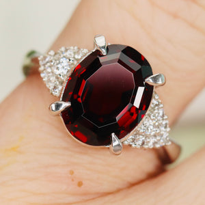 Step cut 4.34ct oval garnet and diamond ring in platinum