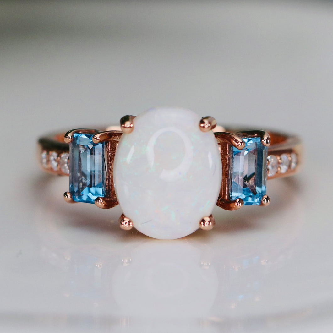 Opal and blue topaz ring in rose gold