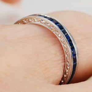 Engraved sapphire eternity band in engraved platinum