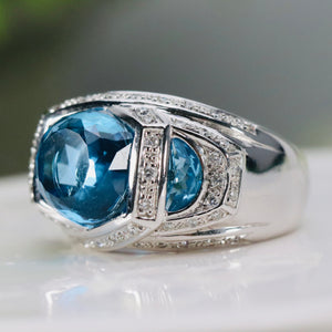 Blue topaz ring with floating diamonds in 14k white gold