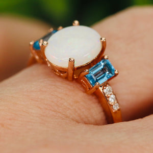 Opal and blue topaz ring in rose gold