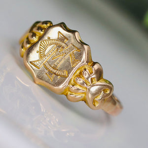 Antique shield shaped MC/CM signet ring in yellow gold