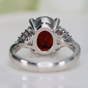 Step cut 4.34ct oval garnet and diamond ring in platinum