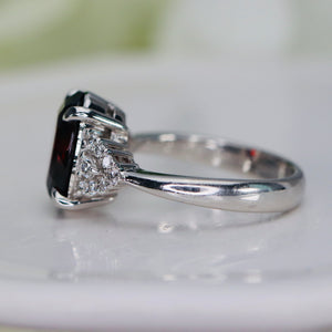 Step cut 4.34ct oval garnet and diamond ring in platinum
