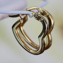 Load image into Gallery viewer, Heart shaped hoops in 14k yellow gold