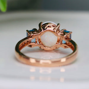 Opal and blue topaz ring in rose gold
