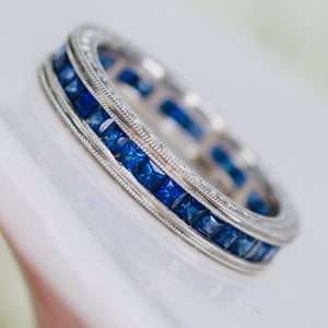 Engraved sapphire eternity band in engraved platinum