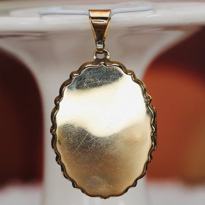 Large oval engraved locket in yellow gold