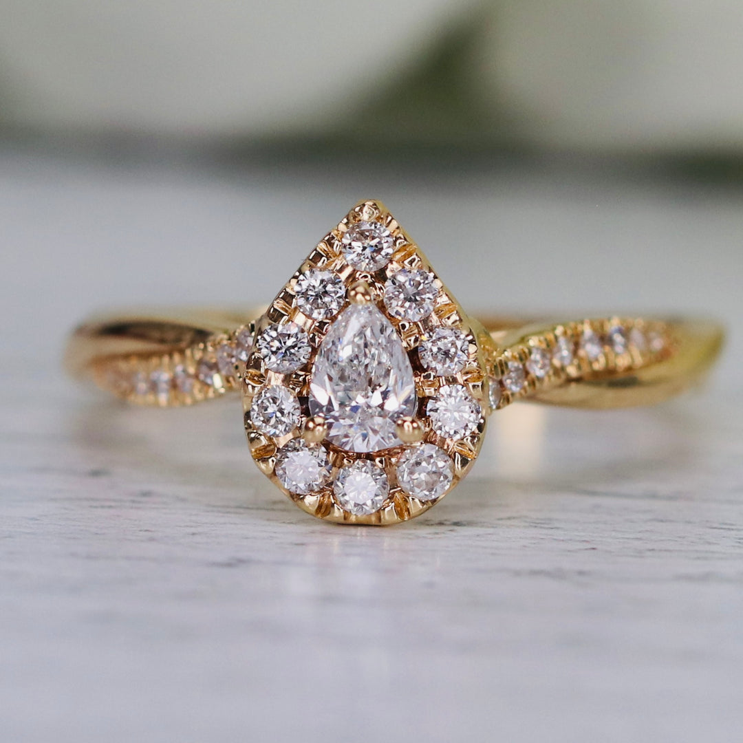 Pear shape diamond cluster ring in 14k yellow gold