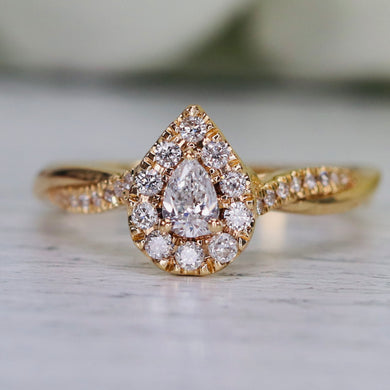 Pear shape diamond cluster ring in 14k yellow gold