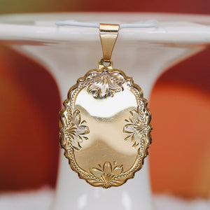 Large oval engraved locket in yellow gold