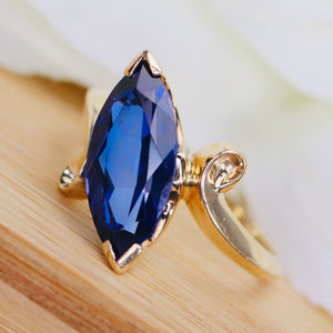 Marquise cut synthetic blue sapphire ring in yellow gold